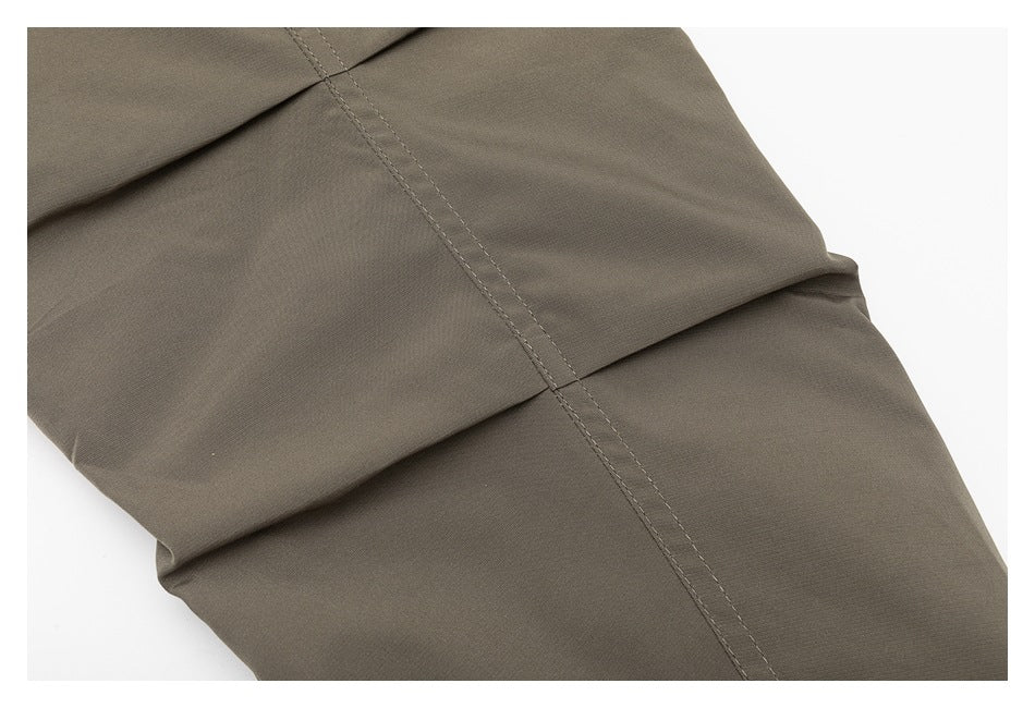 Close-up showing stitched panel seams on the taupe jacket.