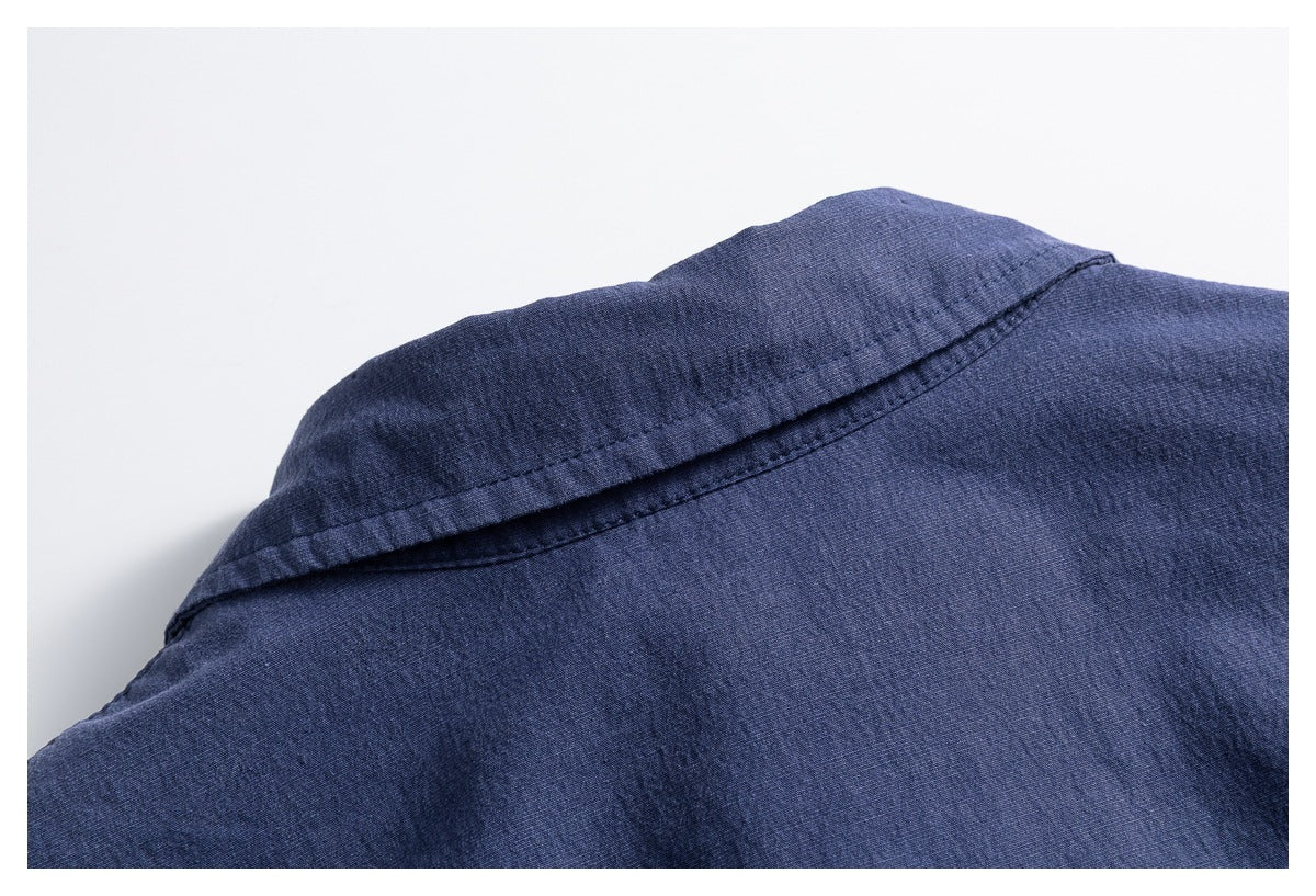 Close-up of the back collar and shoulder seam of a blue button-up shirt.