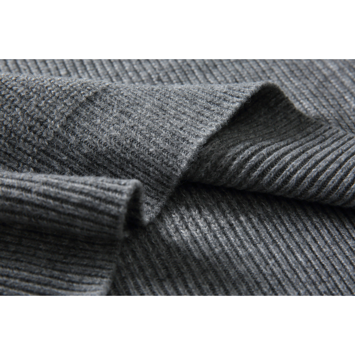 Close-up of gray rib-knit sweater fabric with a folded ribbed edge.