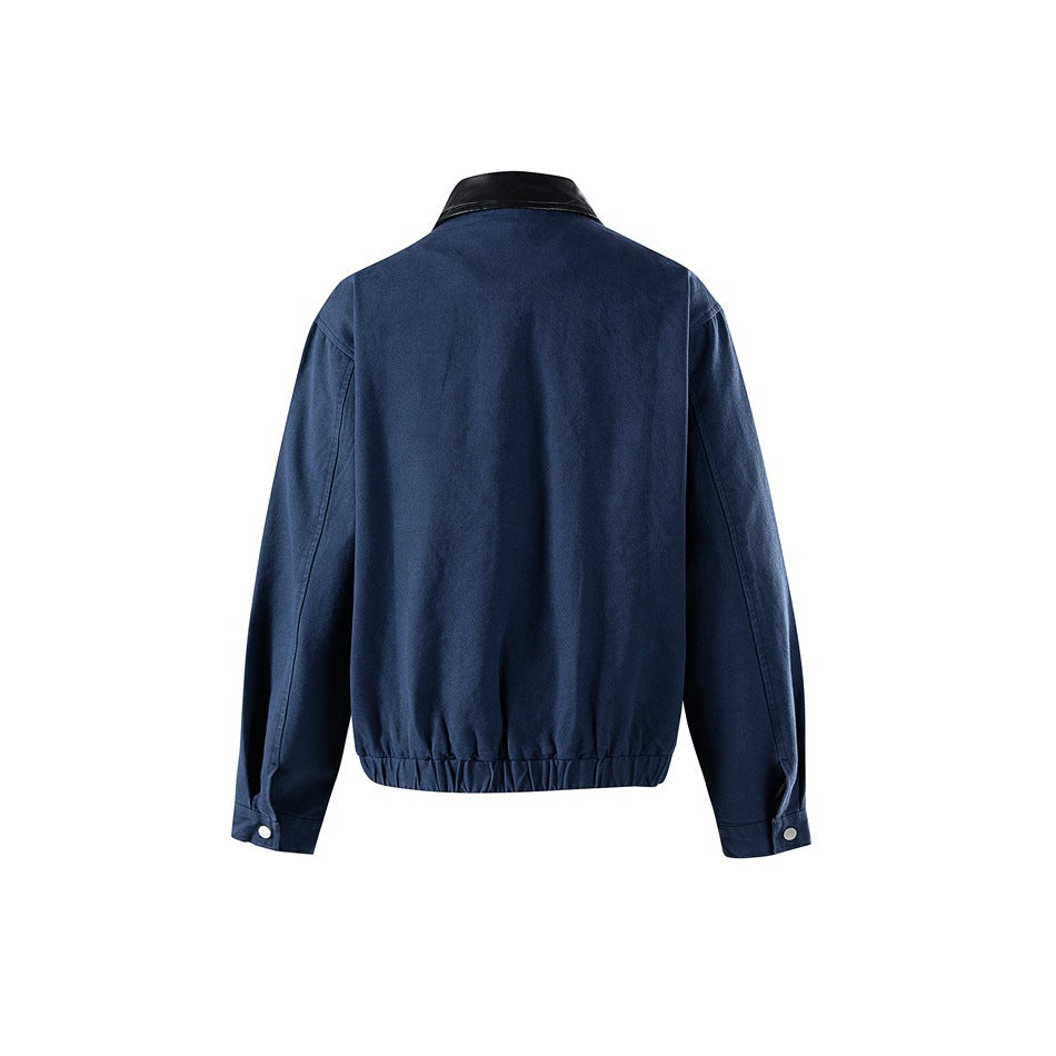 Back view of a navy jacket with a black collar, long sleeves, cuff snaps and a gathered hem.