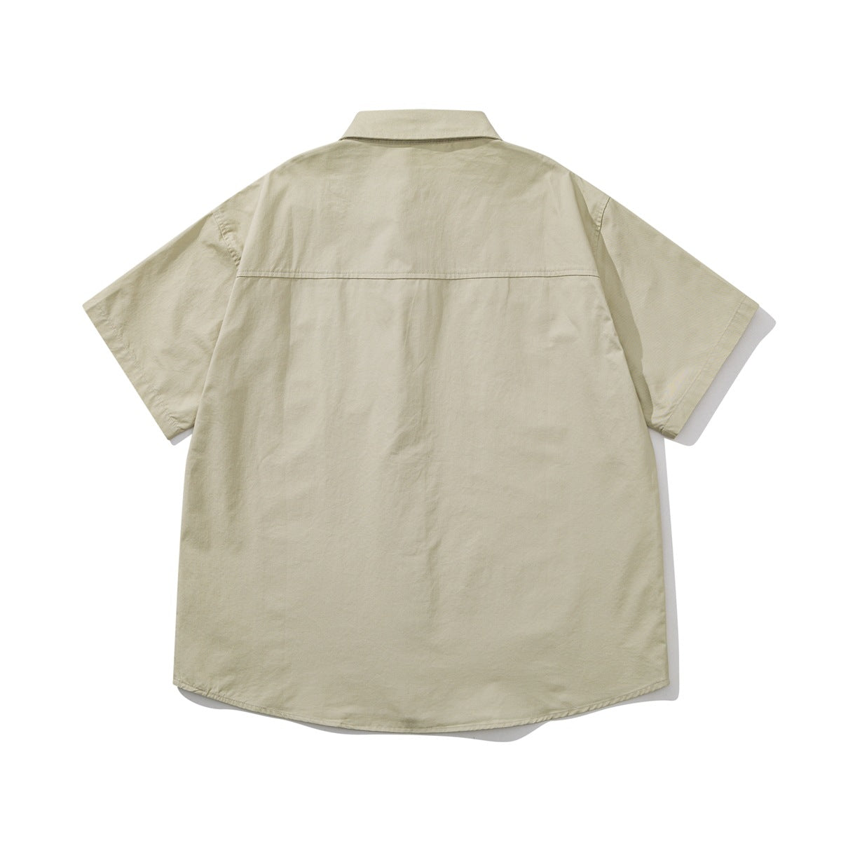 Back view of a light beige short-sleeve button-up shirt laid flat, with a yoke seam.
