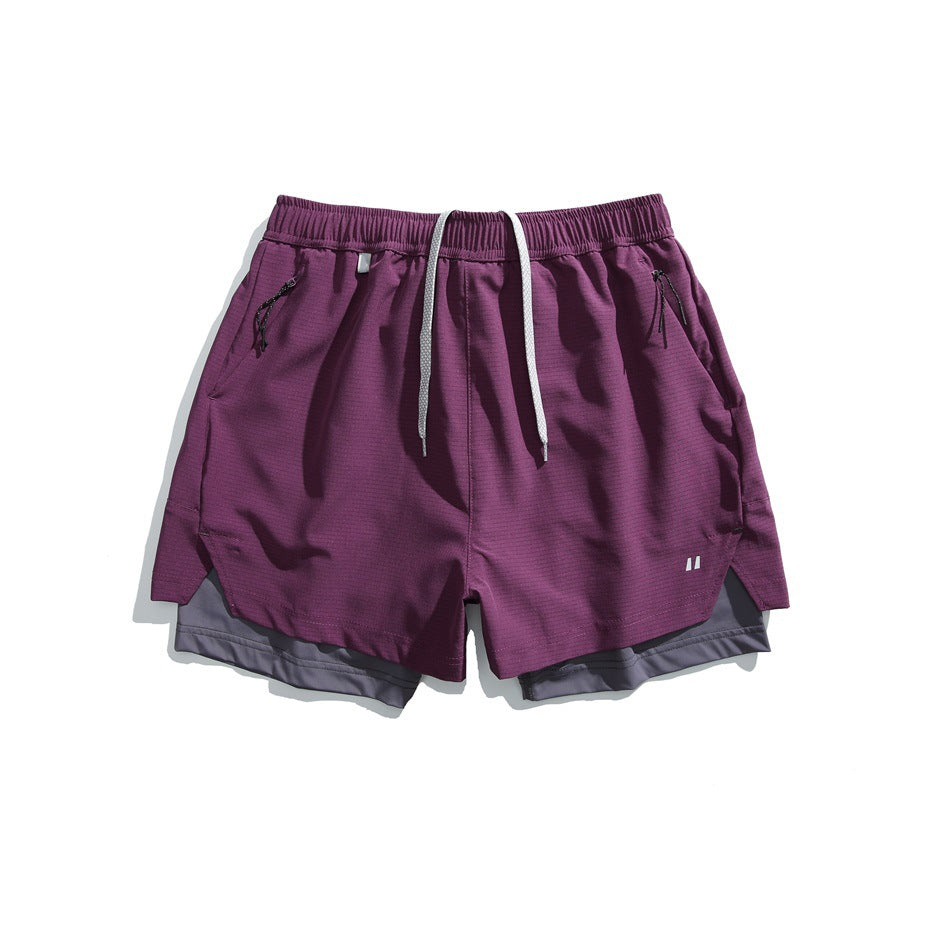 Magenta double-layer athletic shorts with gray inner layer, drawcord and zip pockets, flat lay front view