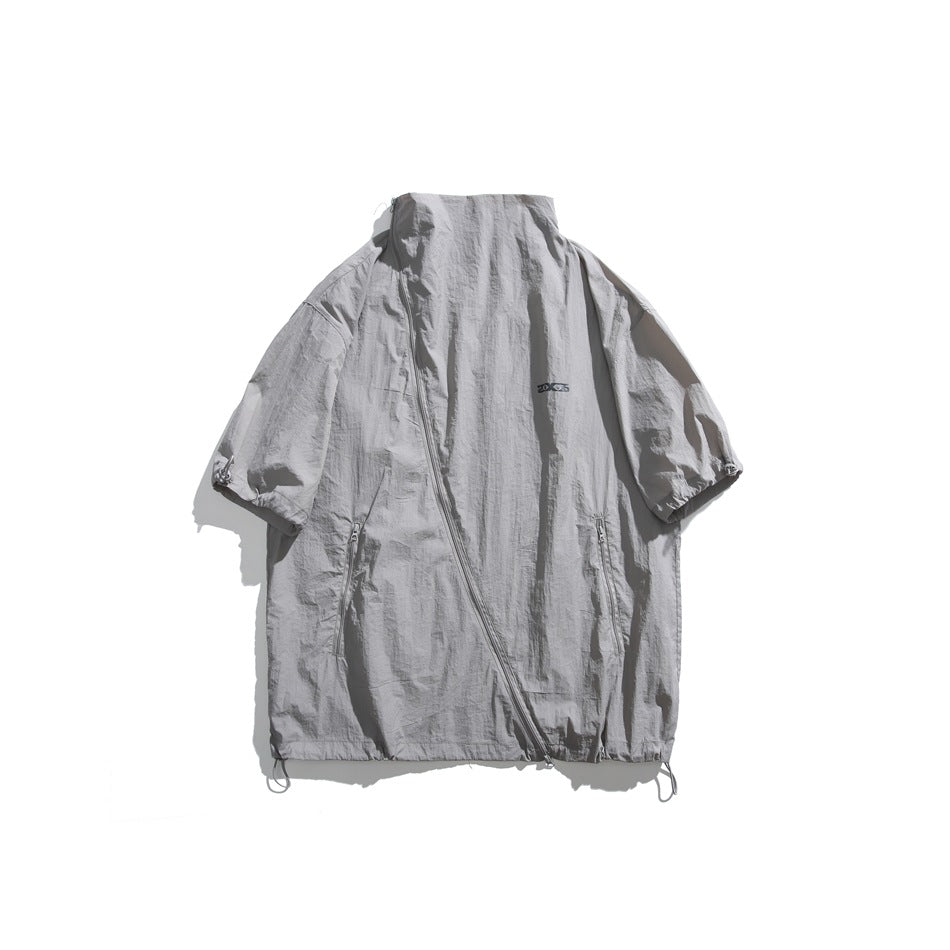 Dark gray short-sleeve stand-collar jacket flat lay with diagonal zipper, zip pockets and toggle cuffs