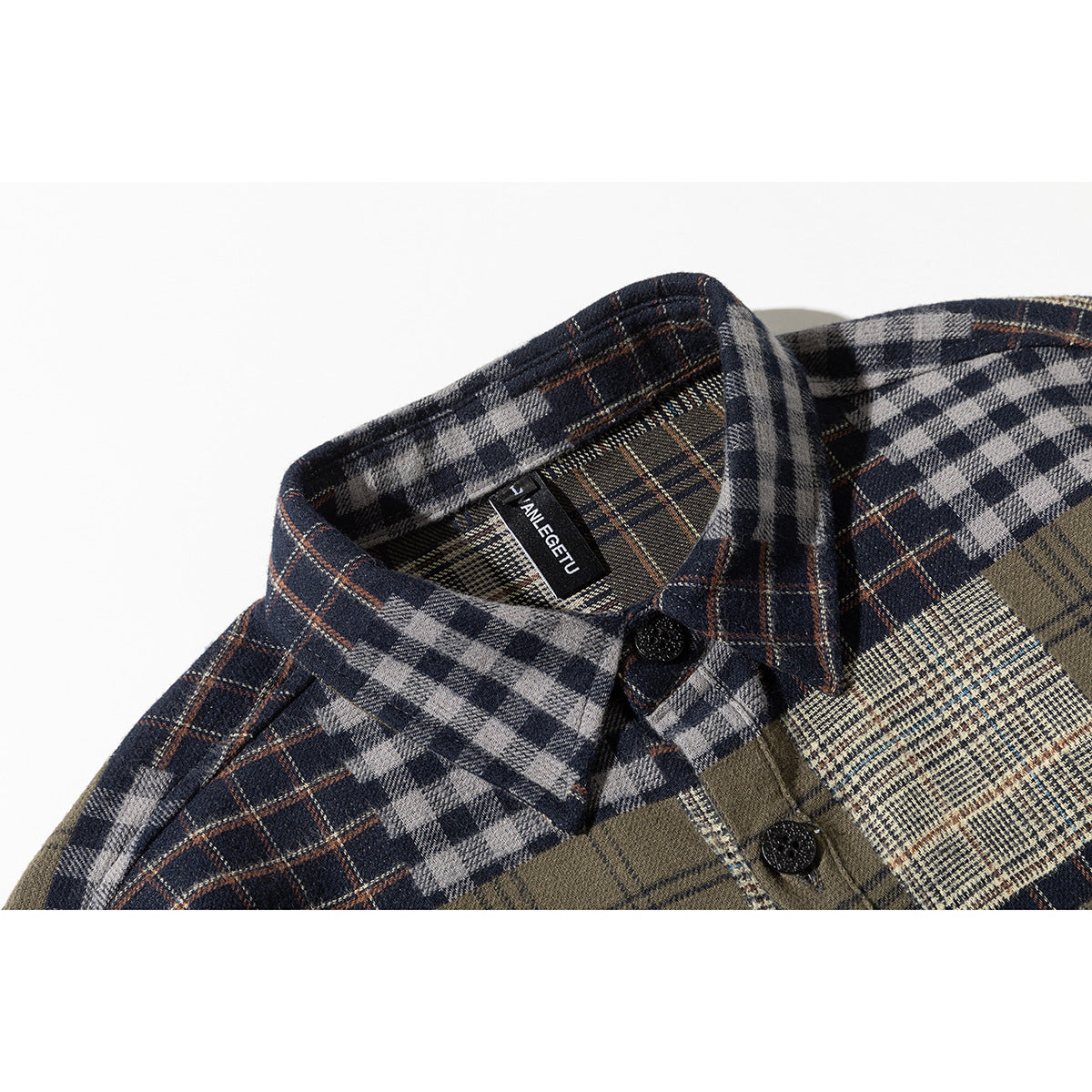 Close-up of a shirt collar and buttons in mixed navy, gray, cream, and olive plaid.