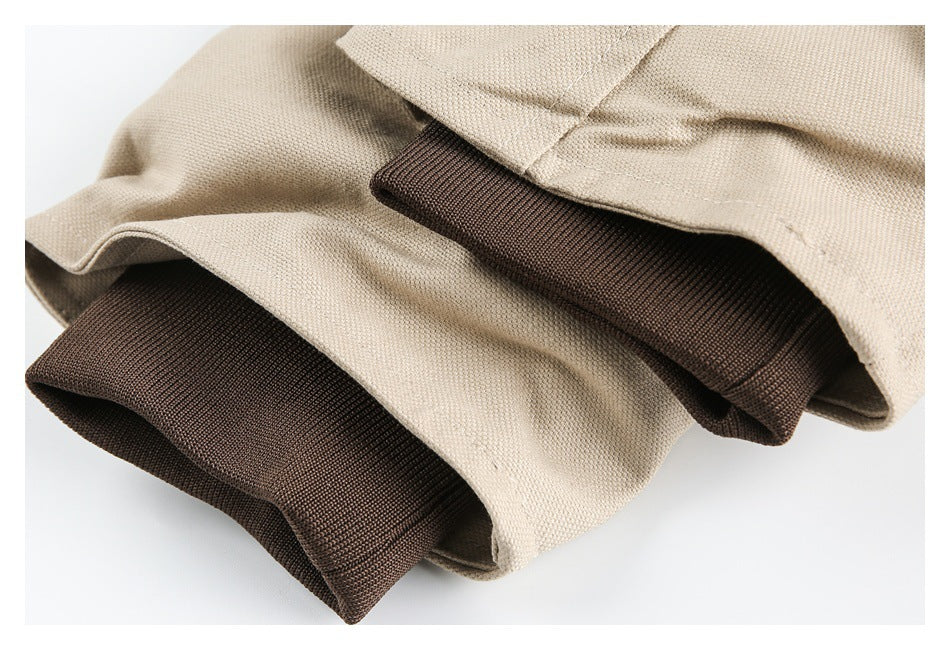 Close-up of beige coat fabric layered with dark brown ribbed cuffs.
