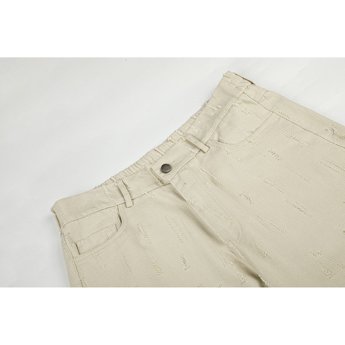 Close-up of light beige trousers showing the waistband, button, belt loops, and front pocket.
