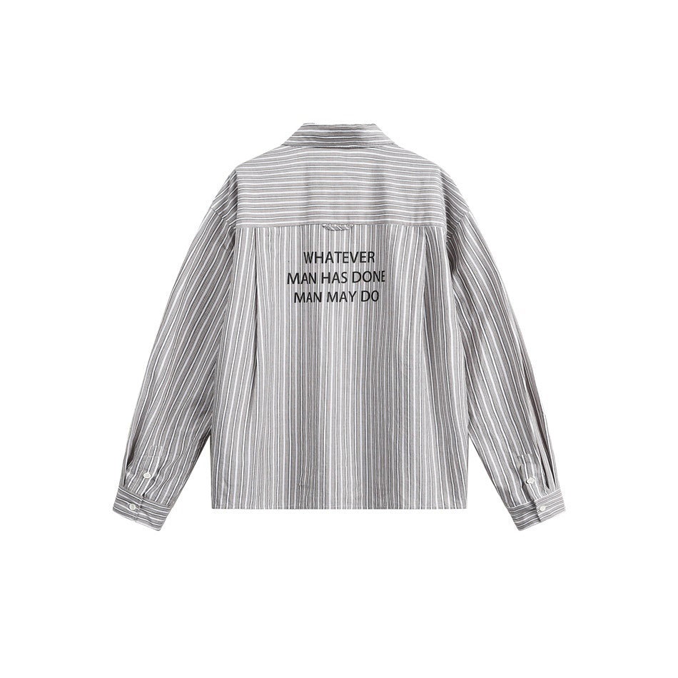 Rear view of a gray-and-white striped long-sleeve shirt with black lettering across the upper back.