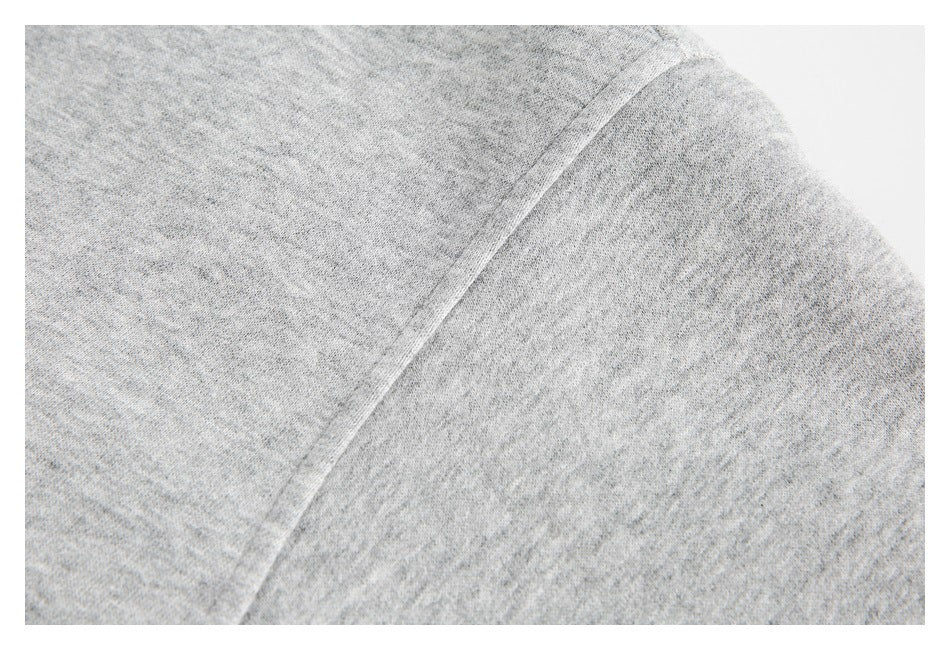 Close-up of a gray top's shoulder seam and sleeve.
