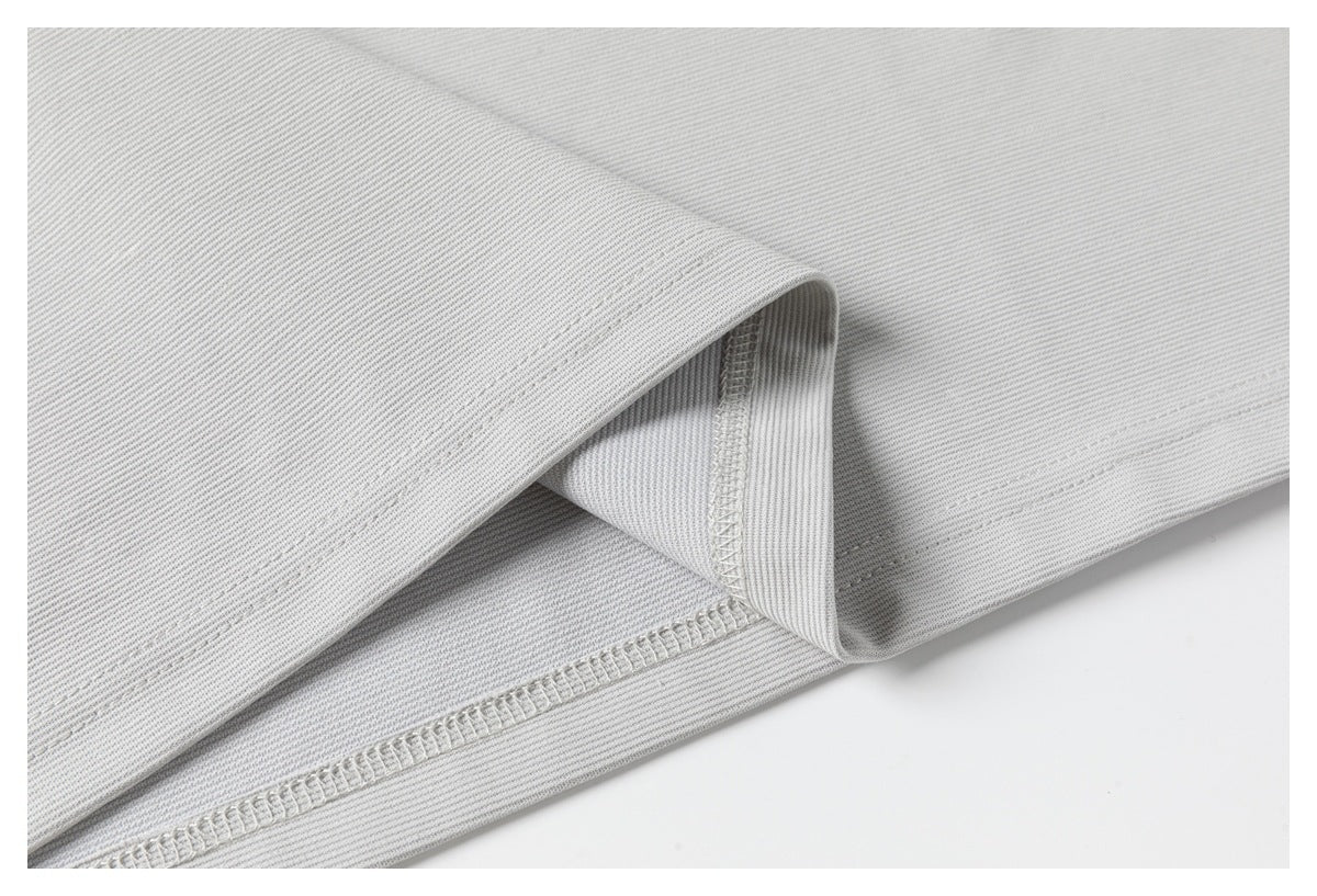 Close-up of the gray polo's inside seam and overlocked stitching.