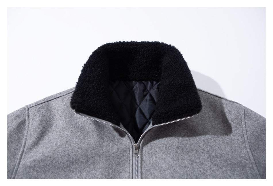 Close-up of the gray jacket with its collar open, showing black plush trim and dark quilted lining.
