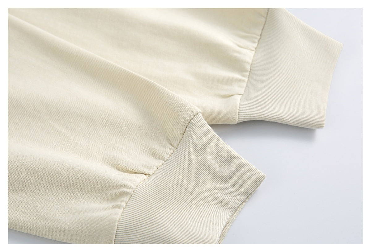 Close-up of the ivory shirt's short sleeve and wide ribbed cuff.