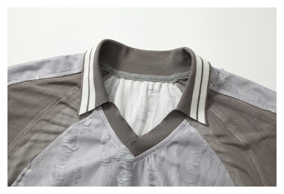 Close-up of the top's striped ribbed collar, V-neck trim, and taupe mesh shoulder panels.