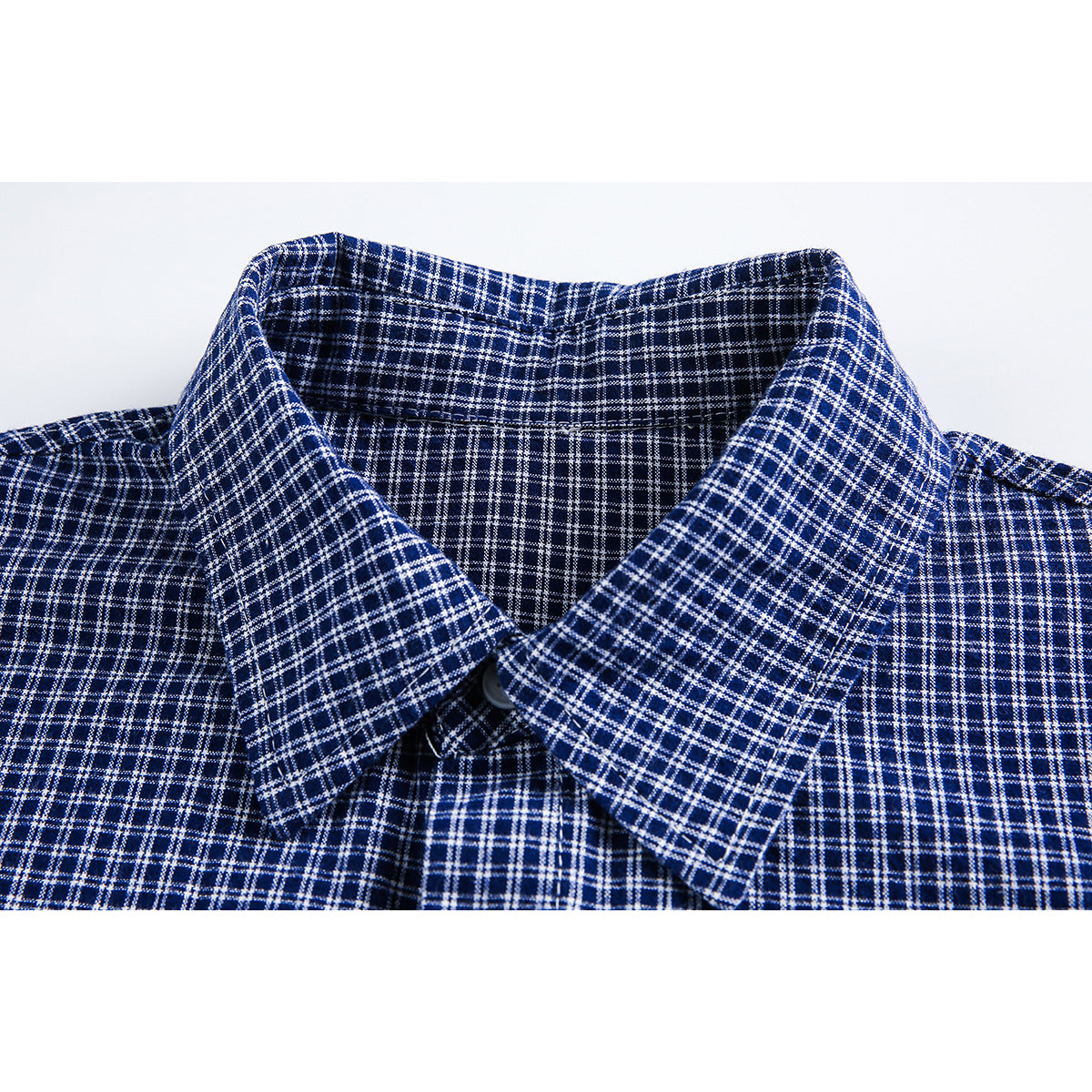 Close-up of a pointed collar on a navy shirt with a white windowpane check.
