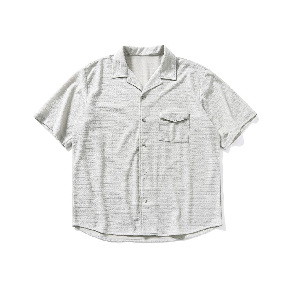 Gray-green short-sleeve camp-collar shirt with chest flap pocket and textured stripes, flat lay front view