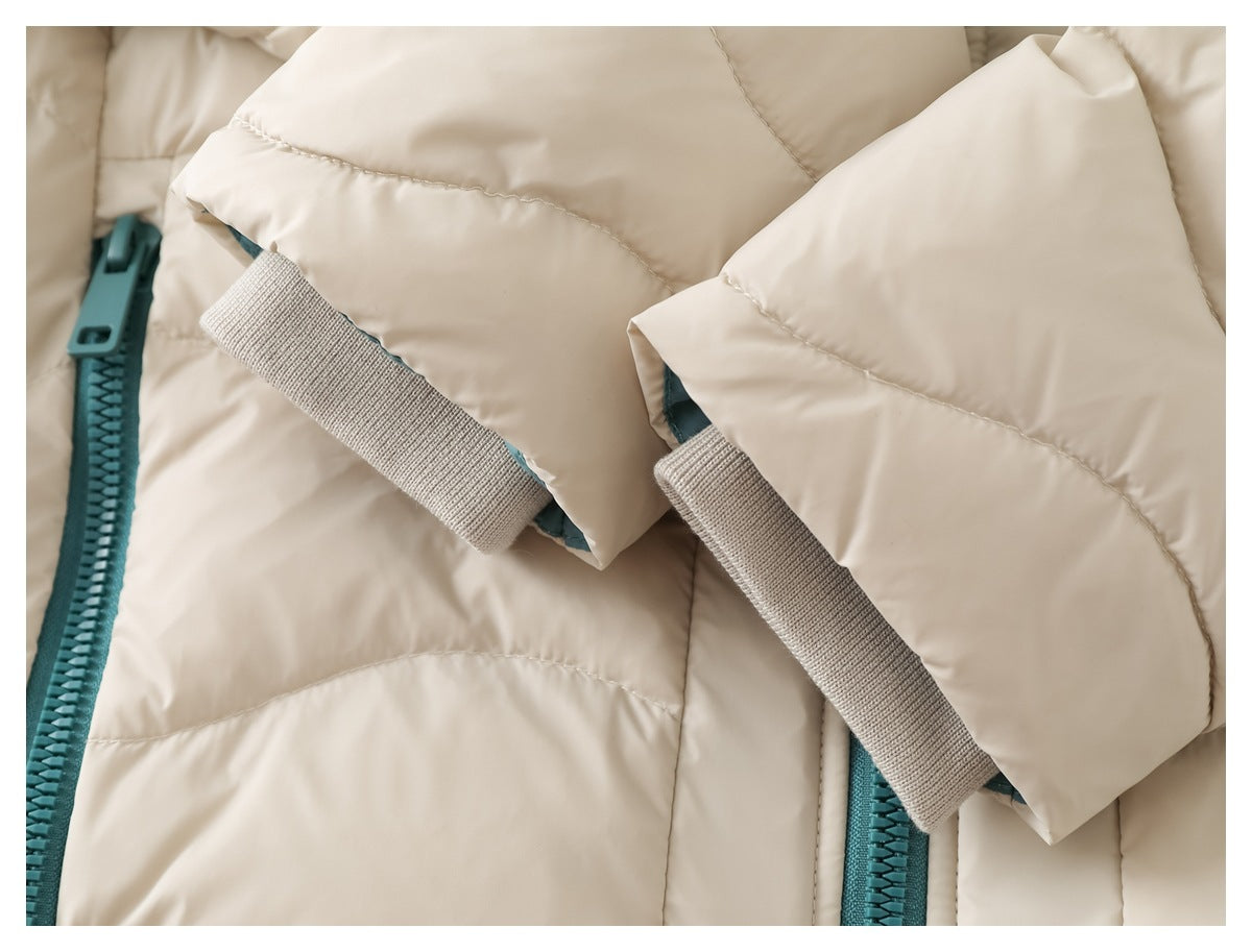 Close-up of beige ribbed inner cuffs on the sleeves of a cream quilted jacket.