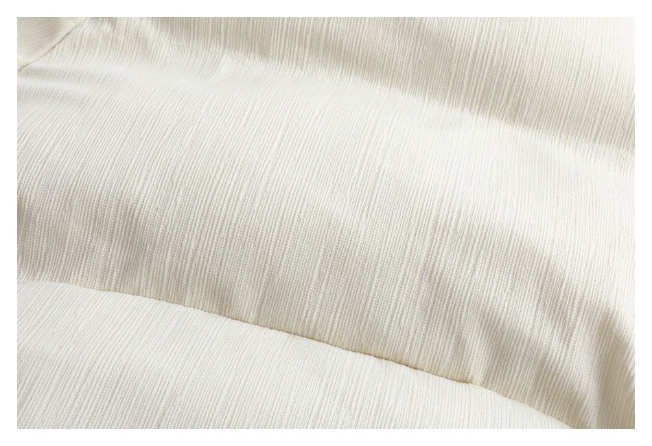 Close-up showing the fine vertical texture and stitched panel seam of ivory fabric.