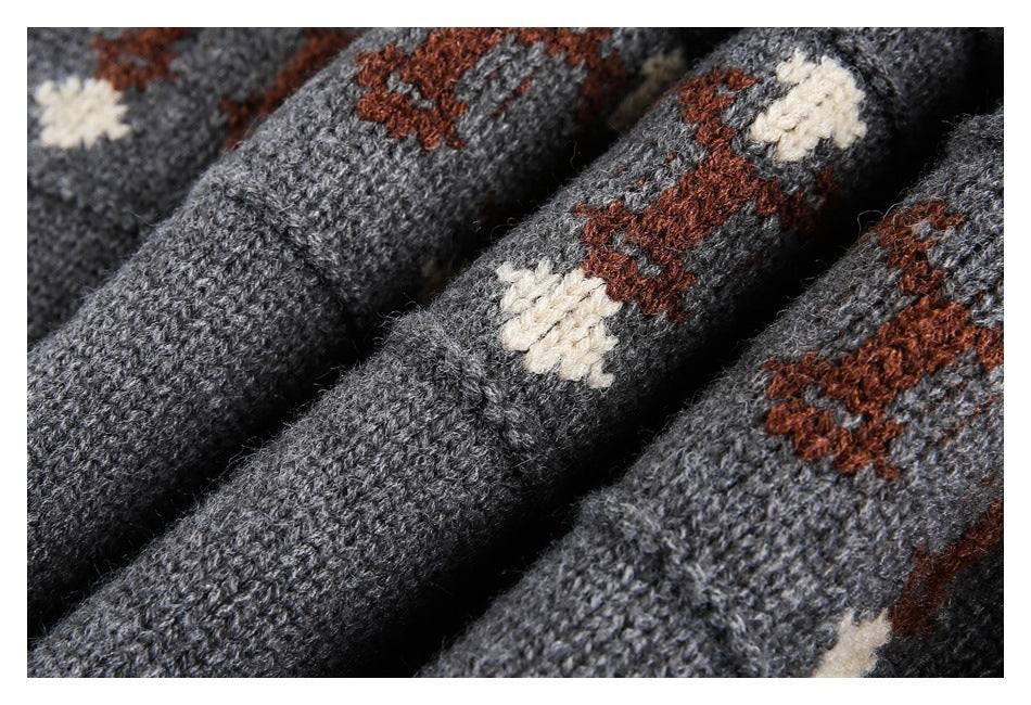 Macro view of charcoal knit fabric with raised cream and rust pattern details.