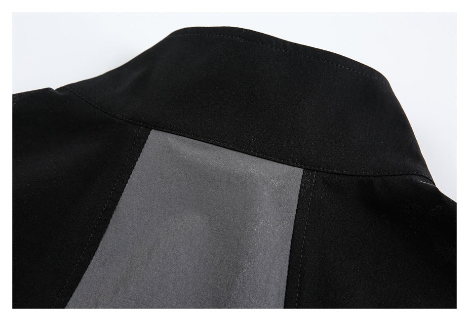 Close-up of a black garment collar and a charcoal-gray panel below it.