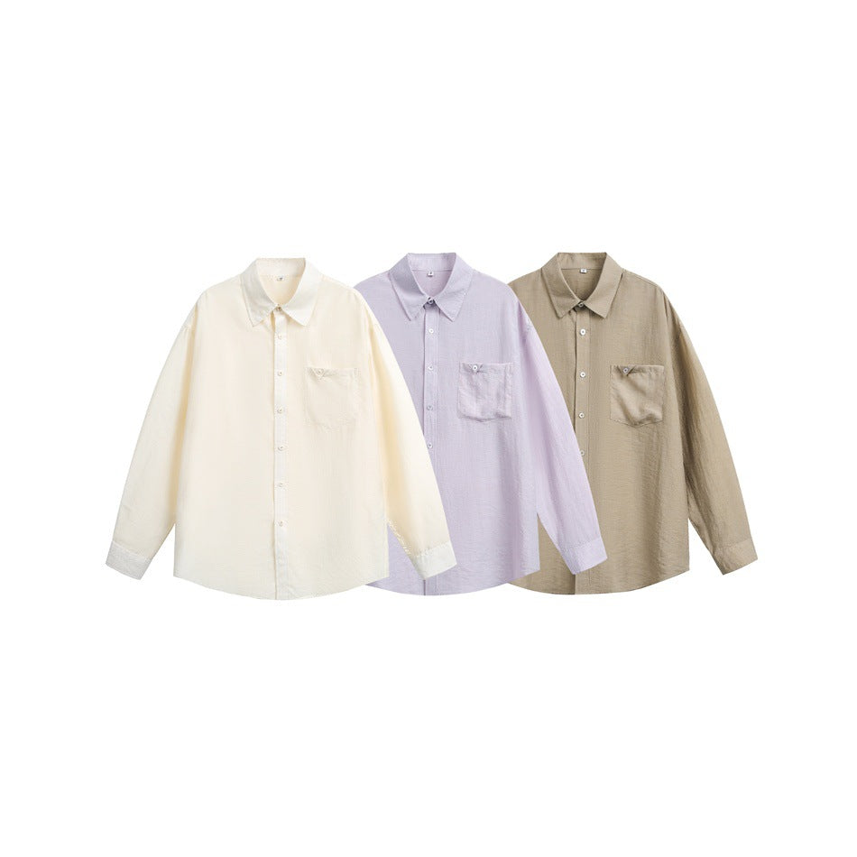 Three long-sleeved button-up shirts with chest pockets in ivory, pale lavender, and taupe.