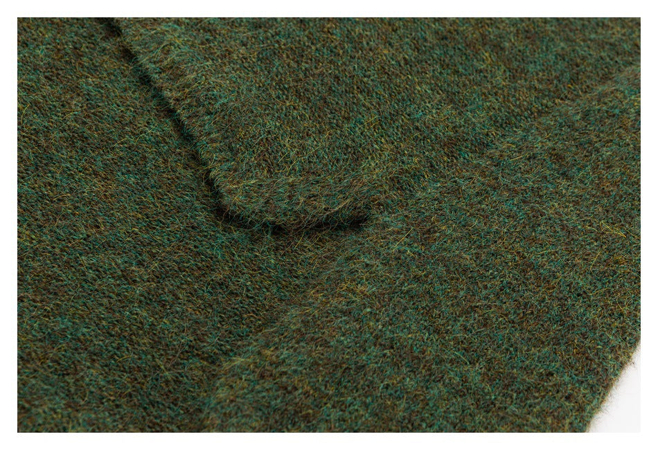Close-up of a seam or folded section in mottled teal-brown fuzzy knit.