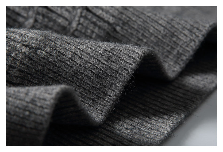 Macro view of the gray sweater's knit texture and thick folded edge.