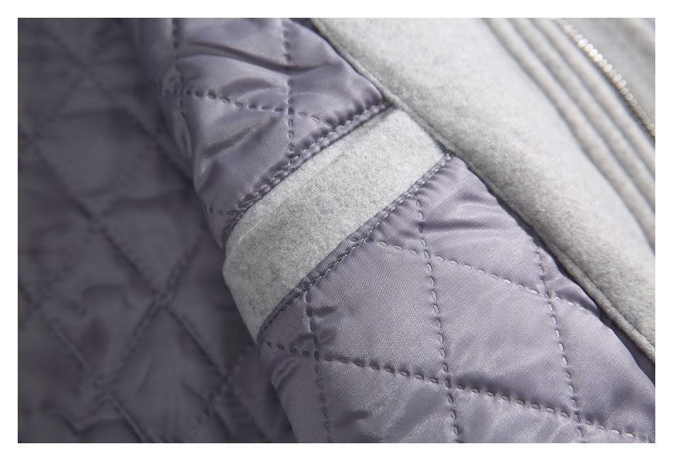 Close-up of gray quilted lining beside the light gray coat shell.