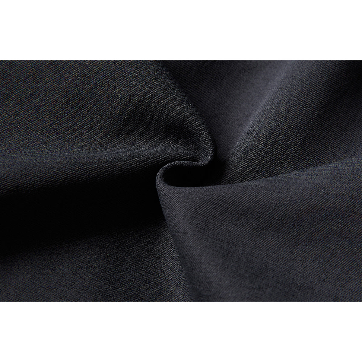 Macro close-up of dark charcoal fabric draped to show its fine woven texture.