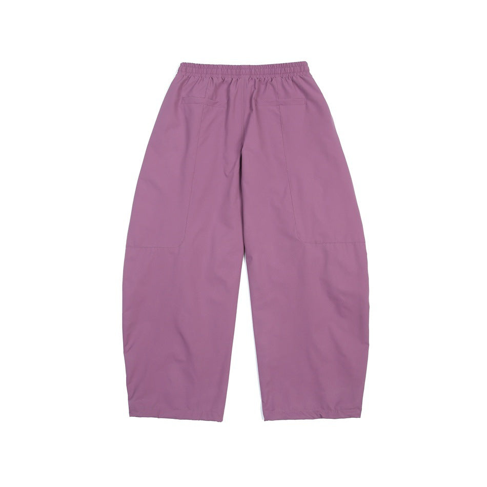 Back view of mauve wide-leg pants with an elastic waistband and two large patch pockets.