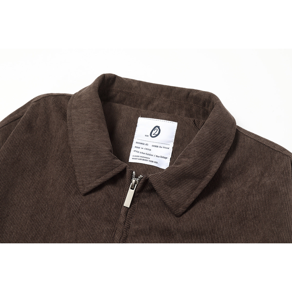 Close-up of a brown ribbed jacket collar, zipper, and interior label.