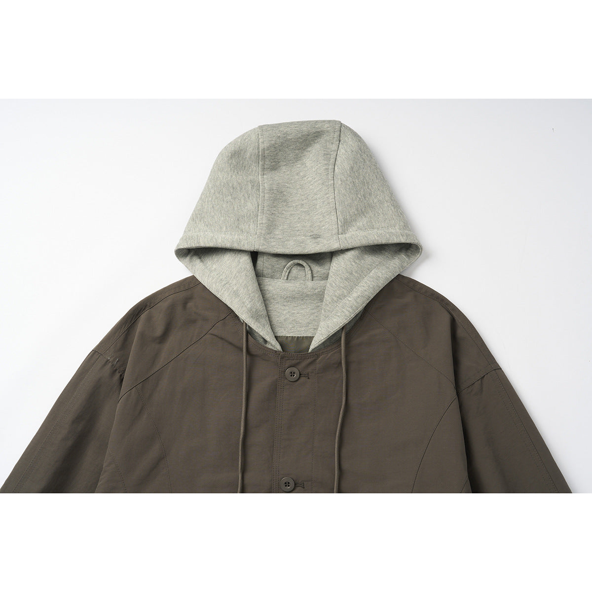 Close-up of a dark brown hooded jacket with a light gray hood lining and button front.