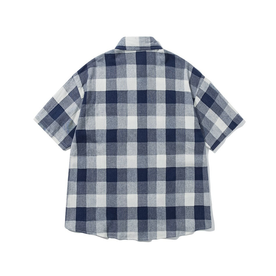 Back view of navy and white check short-sleeve shirt with collar and curved hem