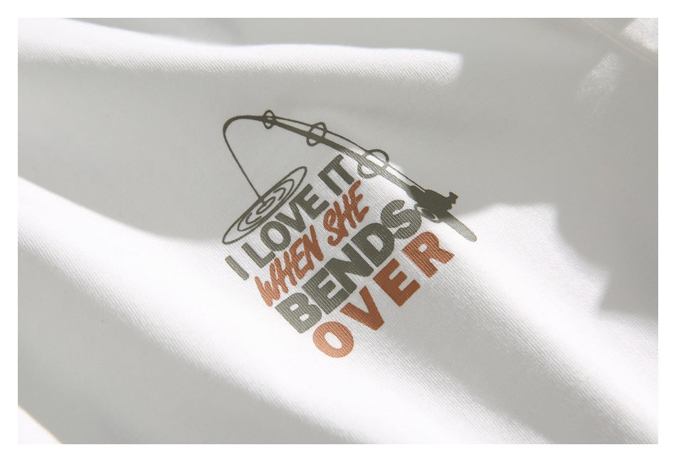 Close-up of a white T-shirt print with a record player and bold gray and rust-colored lettering.