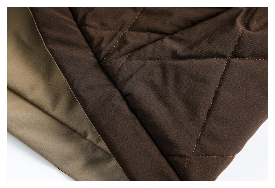 Close-up of dark brown quilted jacket fabric and stitching beside an olive-colored lining panel.