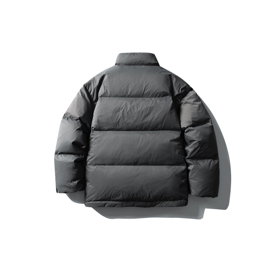 Back view of a charcoal gray puffer jacket with a high collar, long sleeves, and horizontal quilting.