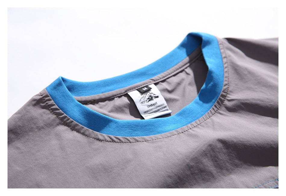 Close-up of the gray shirt's bright blue crew neckline and sewn-in label.