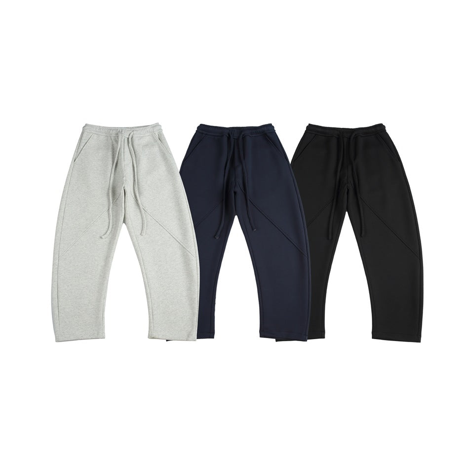 Three pairs of drawstring sweatpants shown from the front in light gray, navy, and black.