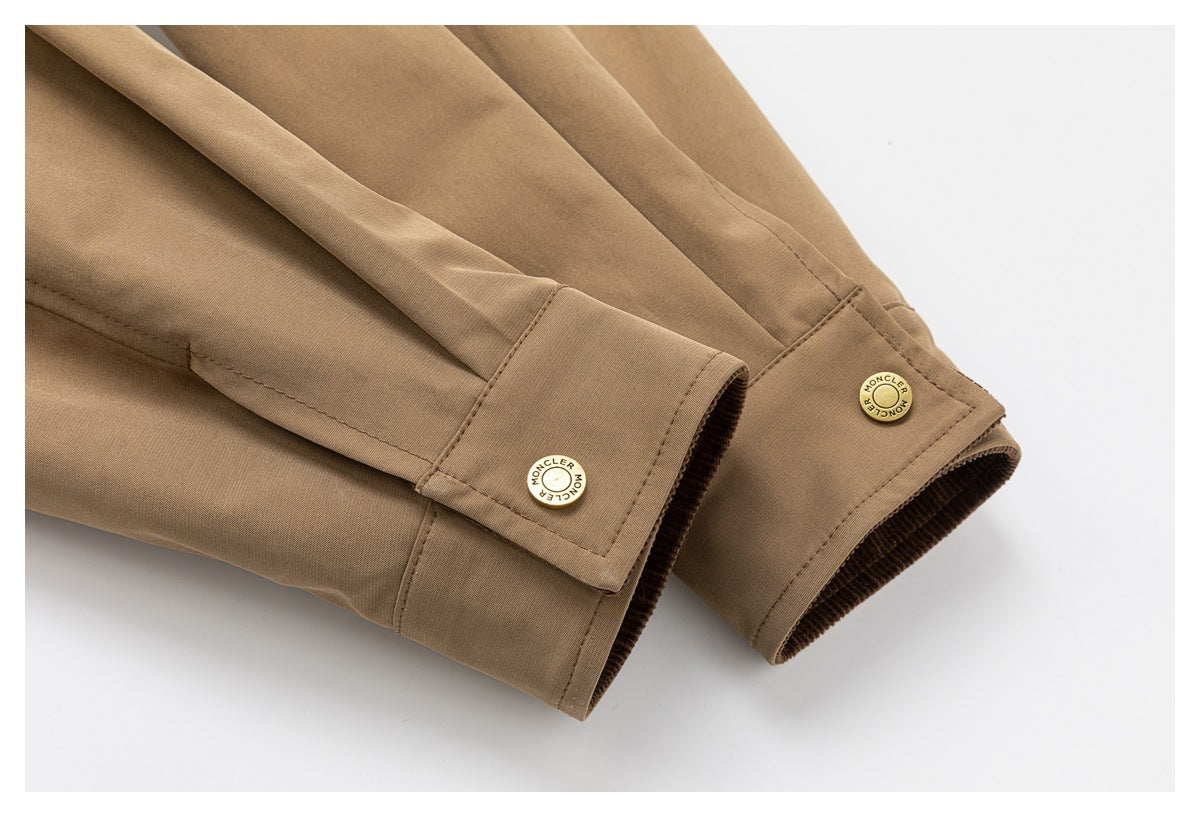 Tan jacket sleeve cuffs with brass buttons and stitched button tabs.
