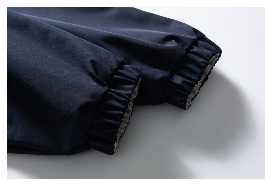 Close-up of a dark navy jacket sleeve with gathered elastic cuffs.