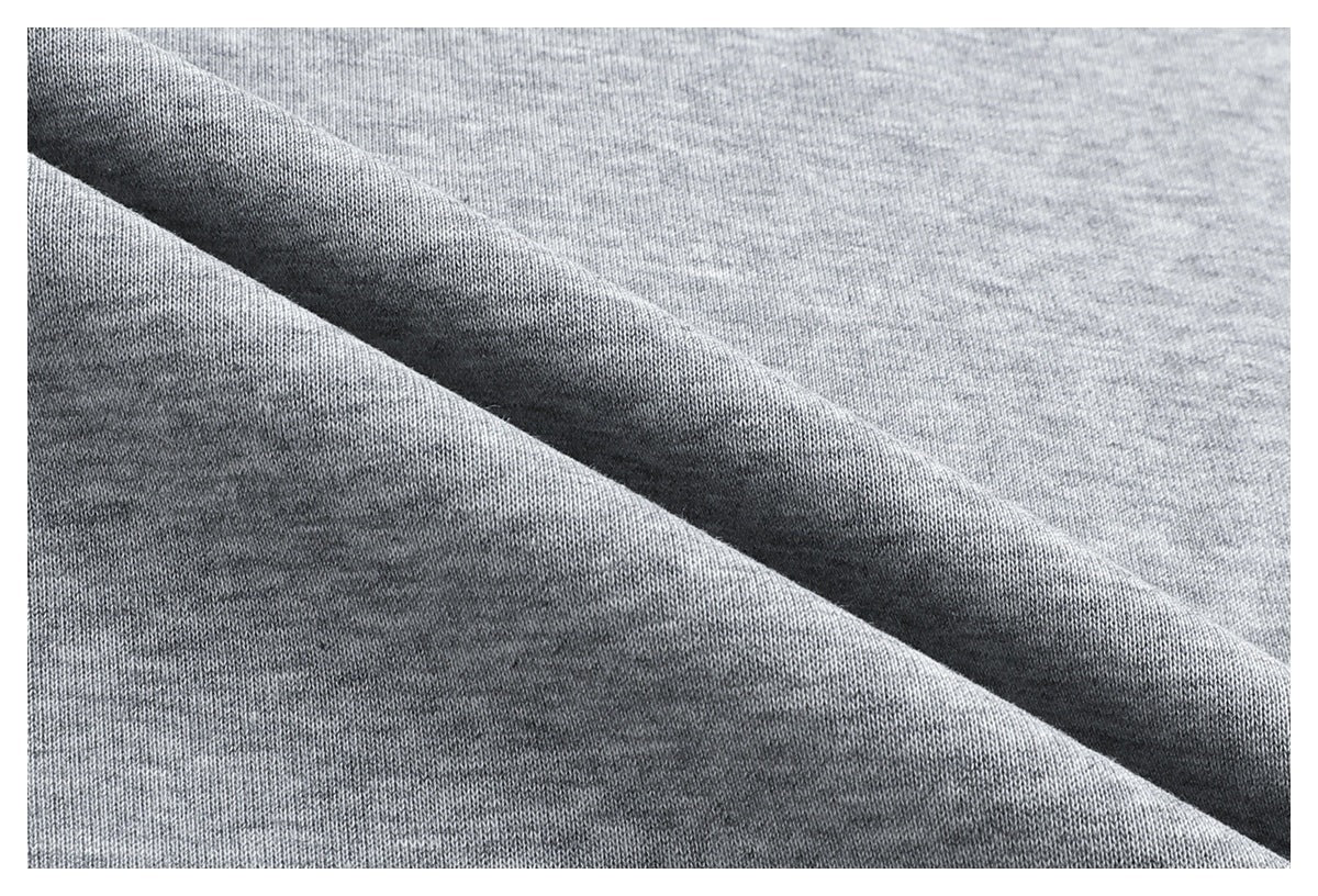 Extreme close-up of heather gray sweatshirt fabric folded to show its surface and knit texture.