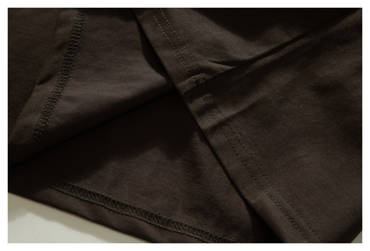 Close-up of overlapping dark brown fabric panels showing seam and overlock stitching.