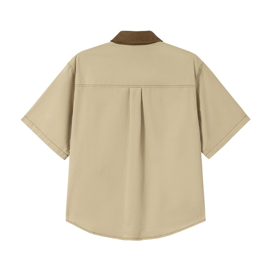 Back view of khaki short-sleeve shirt with brown collar, yoke seam and center pleat on plain background
