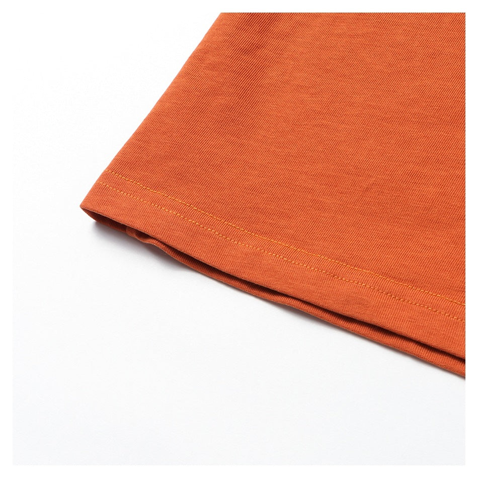 Close-up of the orange garment's double-stitched bottom hem.