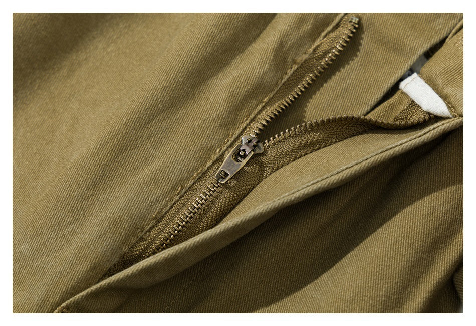 Close-up of the olive-khaki shorts' fly zipper and stitching.
