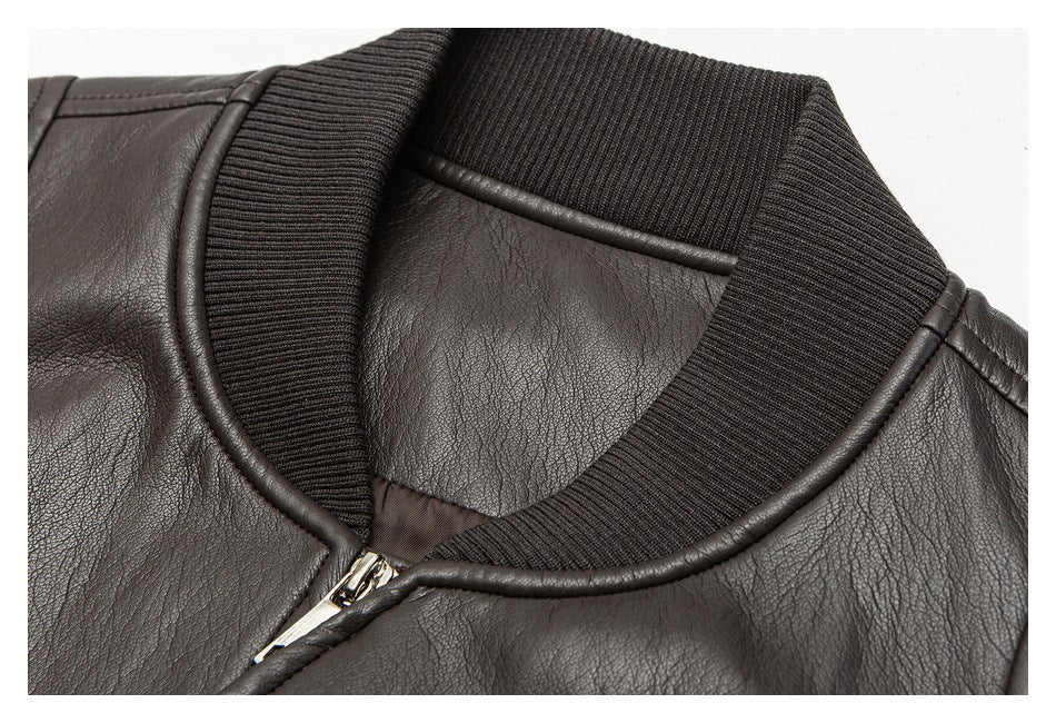 Close-up of the dark brown jacket's ribbed collar, piped neckline and partial zipper.