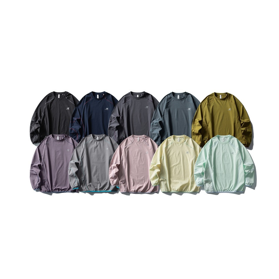 Ten long-sleeve crewneck tops arranged in two rows in assorted dark, muted, and pastel colors.