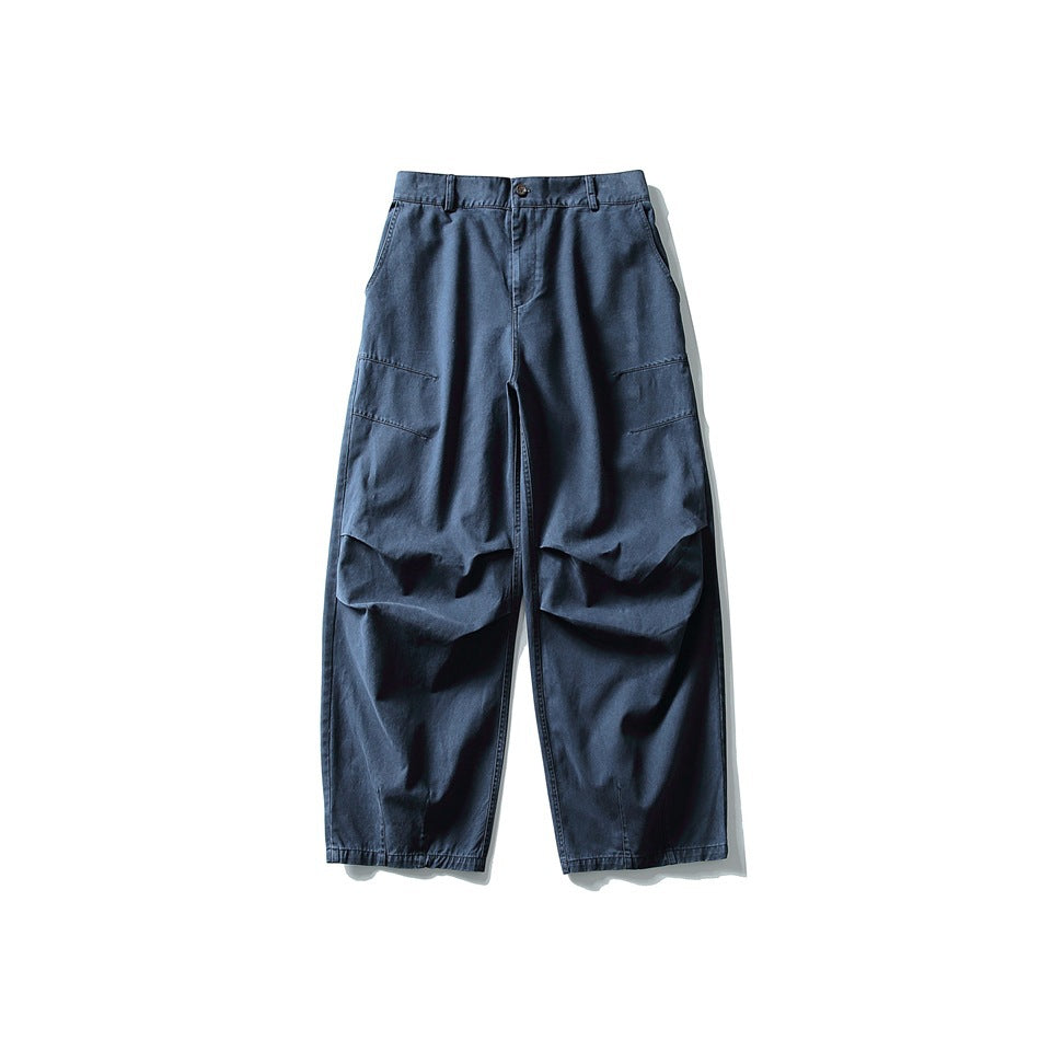 Blue wide-leg trousers flat lay front view with knee pleats and slanted thigh seams