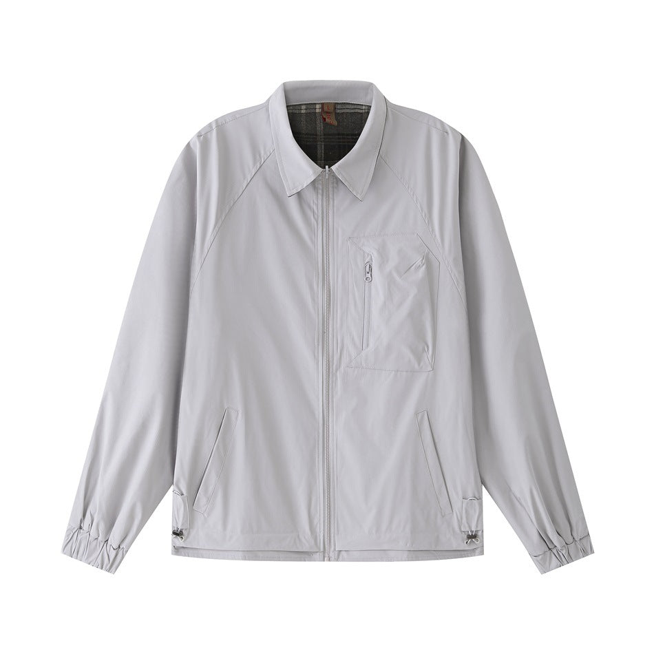 Light gray zip-front jacket with pointed collar, zippered chest pocket and elastic cuffs, flat lay front view