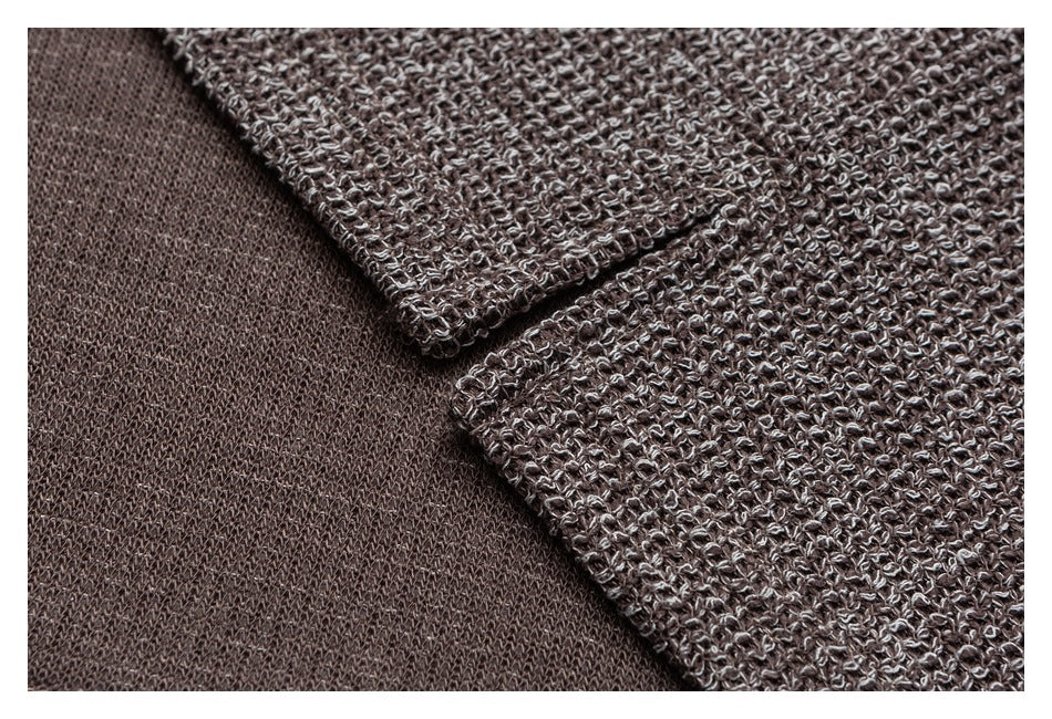 Close-up of the cardigan's taupe knit exterior and smooth inner side at a folded edge.