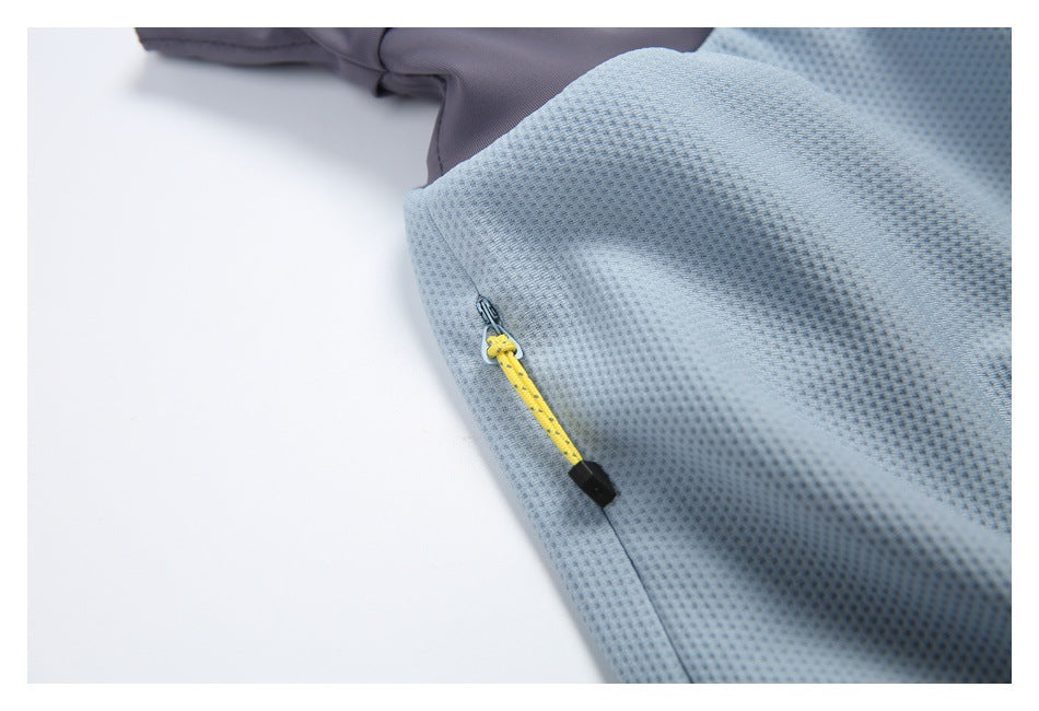 Close-up of a yellow zipper pull with black tip on light blue textured skirt fabric.