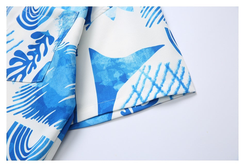 Close-up of the short sleeve cuff and stitched hem on the blue-and-white printed shirt.